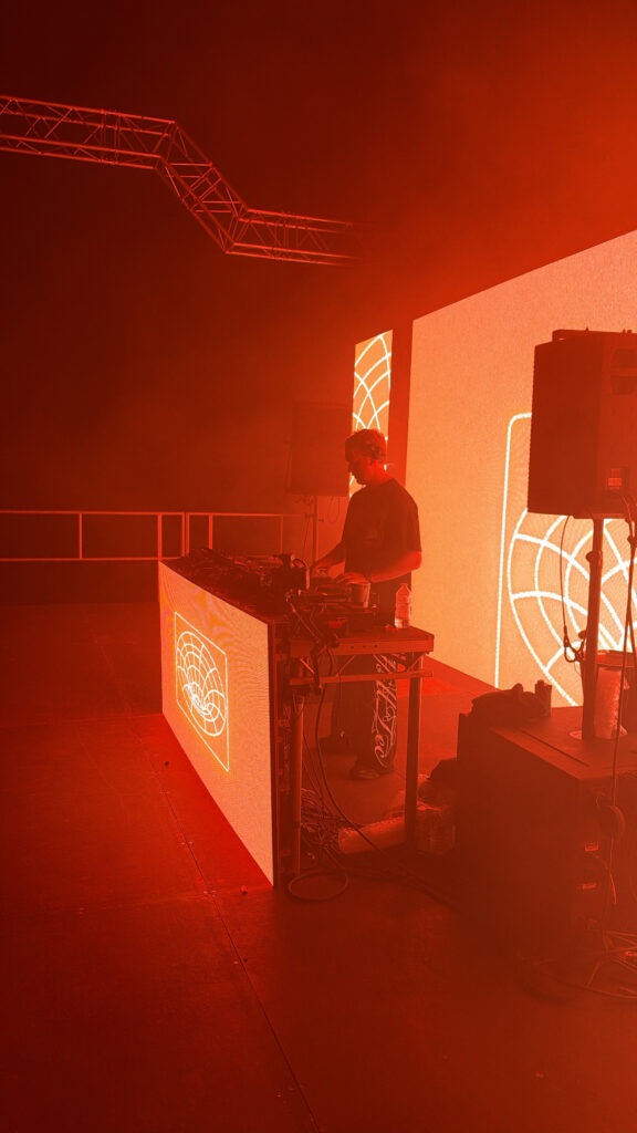 DJ playing a set in red light