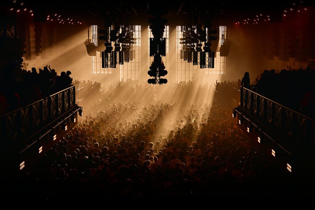 Club crowd under golden spotlights